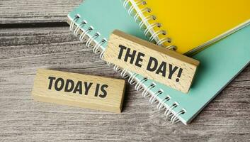 today is the day symbol. Concept words return on assets on wooden blocks. photo
