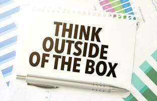 think outside of the box on paper sheet and charts photo