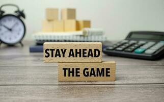 stay ahead the game is shown on a conceptual photo using wooden blocks
