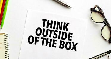 think outside of the box on white paper sheet photo