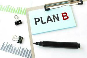 Paper plate, marker, diagram, chart and office tools. Text PLAN B photo