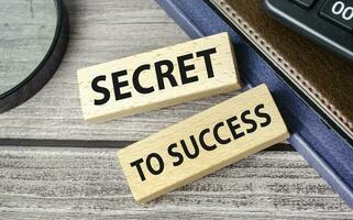 secret to success . text on wooden blocks on wooden background with office supplies photo