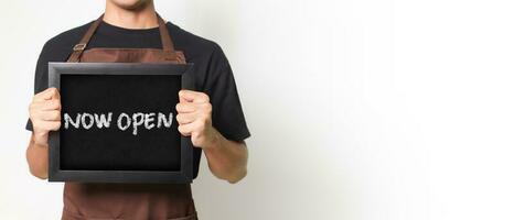 Cropped portrait of Asian barista man holding a blackboard holding a blackboard that says Now Open good for banner. Isolated image on white background photo