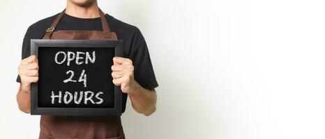 Cropped portrait of Asian barista man holding a blackboard holding a blackboard that says Open 24 Hours good for banner. Isolated image on white background. photo