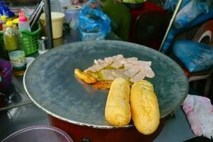 The French bread with fried Ham and chicken. The popular street food in Vang Vieng, Laos. photo