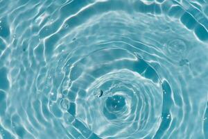 Blue water with ripples on the surface. Defocus blurred transparent blue colored clear calm water surface texture with splashes and bubbles. Water waves with shining pattern texture background. photo