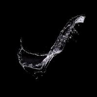 water splash isolated on black background photo