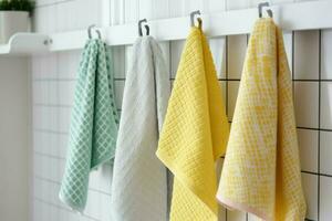 Kitchen colorful towels haning on rack. Generate AI photo