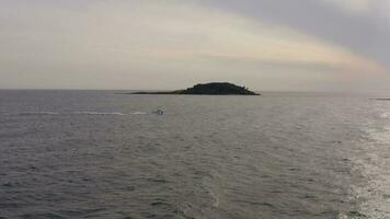 A Fishing Boat Returning To Port At Sunset video