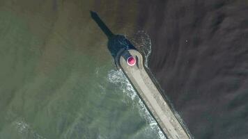 A Lighthouse and Breakwater at the Mouth of a Harbour in the UK video