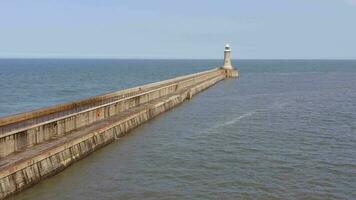 A Lighthouse and Breakwater at the Mouth of a Harbour video