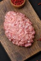 Raw minced beef, pork or chicken meat with salt, spices and herbs photo