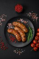 Delicious fried grilled sausages with salt, spices and herbs photo