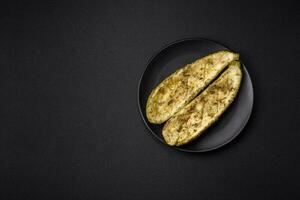 Delicious zucchini cut into two halves baked with salt, spices and herbs photo