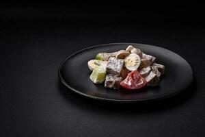 Delicious salad with boiled beef tongue, quail eggs, tomatoes and cucumber photo