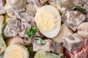 Delicious salad with boiled beef tongue, quail eggs, tomatoes and cucumber photo