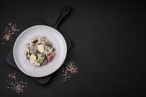 Delicious salad with boiled beef tongue, quail eggs, tomatoes and cucumber photo