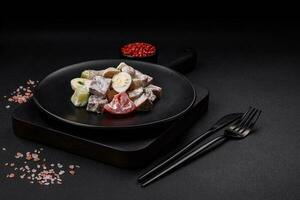 Delicious salad with boiled beef tongue, quail eggs, tomatoes and cucumber photo