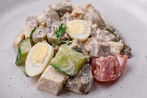 Delicious salad with boiled beef tongue, quail eggs, tomatoes and cucumber photo