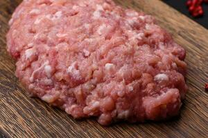 Raw minced beef, pork or chicken meat with salt, spices and herbs photo