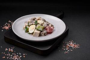 Delicious salad with boiled beef tongue, quail eggs, tomatoes and cucumber photo