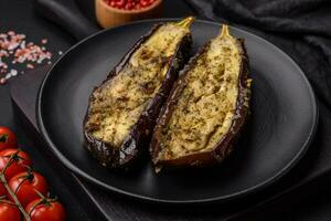 Delicious eggplant cut into two halves baked with salt, spices and herbs photo