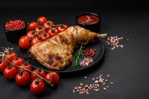 Fresh grilled chicken leg with salt, spices and herbs photo