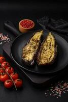 Delicious eggplant cut into two halves baked with salt, spices and herbs photo