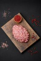 Raw minced beef, pork or chicken meat with salt, spices and herbs photo