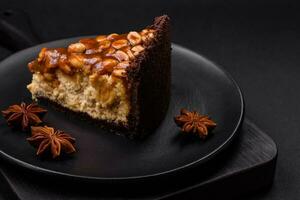 Delicious fresh cheesecake cake or snickers with cream and nuts photo