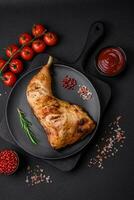 Fresh grilled chicken leg with salt, spices and herbs photo