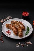 Delicious fried grilled sausages with salt, spices and herbs photo