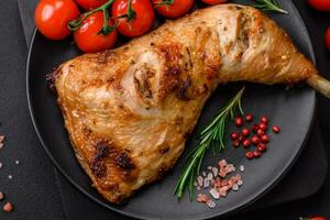 Fresh grilled chicken leg with salt, spices and herbs photo