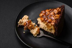 Delicious fresh cheesecake cake or snickers with cream and nuts photo