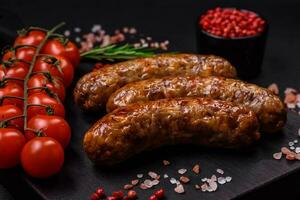 Delicious fried grilled sausages with salt, spices and herbs photo