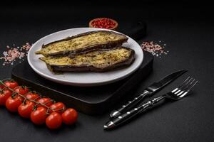 Delicious eggplant cut into two halves baked with salt, spices and herbs photo