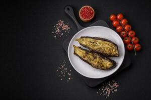 Delicious eggplant cut into two halves baked with salt, spices and herbs photo