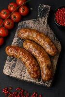 Delicious fried grilled sausages with salt, spices and herbs photo