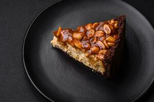 Delicious fresh cheesecake cake or snickers with cream and nuts photo