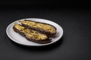 Delicious eggplant cut into two halves baked with salt, spices and herbs photo