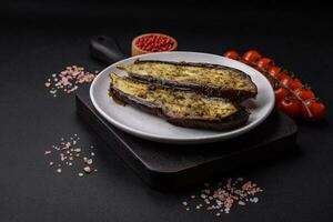 Delicious eggplant cut into two halves baked with salt, spices and herbs photo