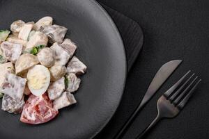 Delicious salad with boiled beef tongue, quail eggs, tomatoes and cucumber photo