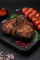 Delicious beef or pork steak on the bone grilled with spices and rosemary photo