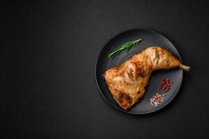 Fresh grilled chicken leg with salt, spices and herbs photo