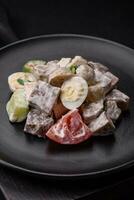 Delicious salad with boiled beef tongue, quail eggs, tomatoes and cucumber photo