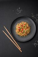 Delicious fresh Asian noodles with vegetables, salt, spices and herbs photo