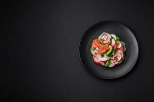 Delicious vegan salad of fresh vegetables of tomatoes, cucumbers and radishes photo