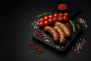 Delicious fried grilled sausages with salt, spices and herbs photo