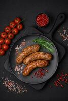 Delicious fried grilled sausages with salt, spices and herbs photo