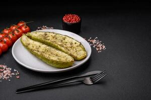 Delicious zucchini cut into two halves baked with salt, spices and herbs photo